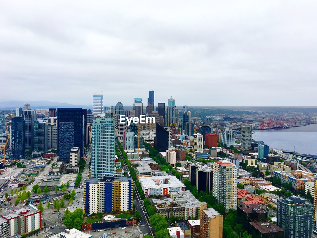 Aerial view of city against cloudy sky