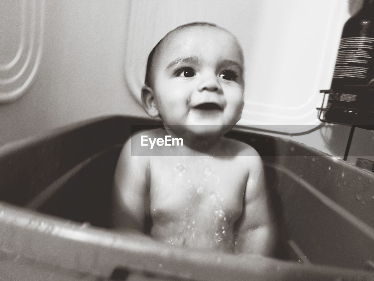 Portrait of cute baby boy bathing in bathroom