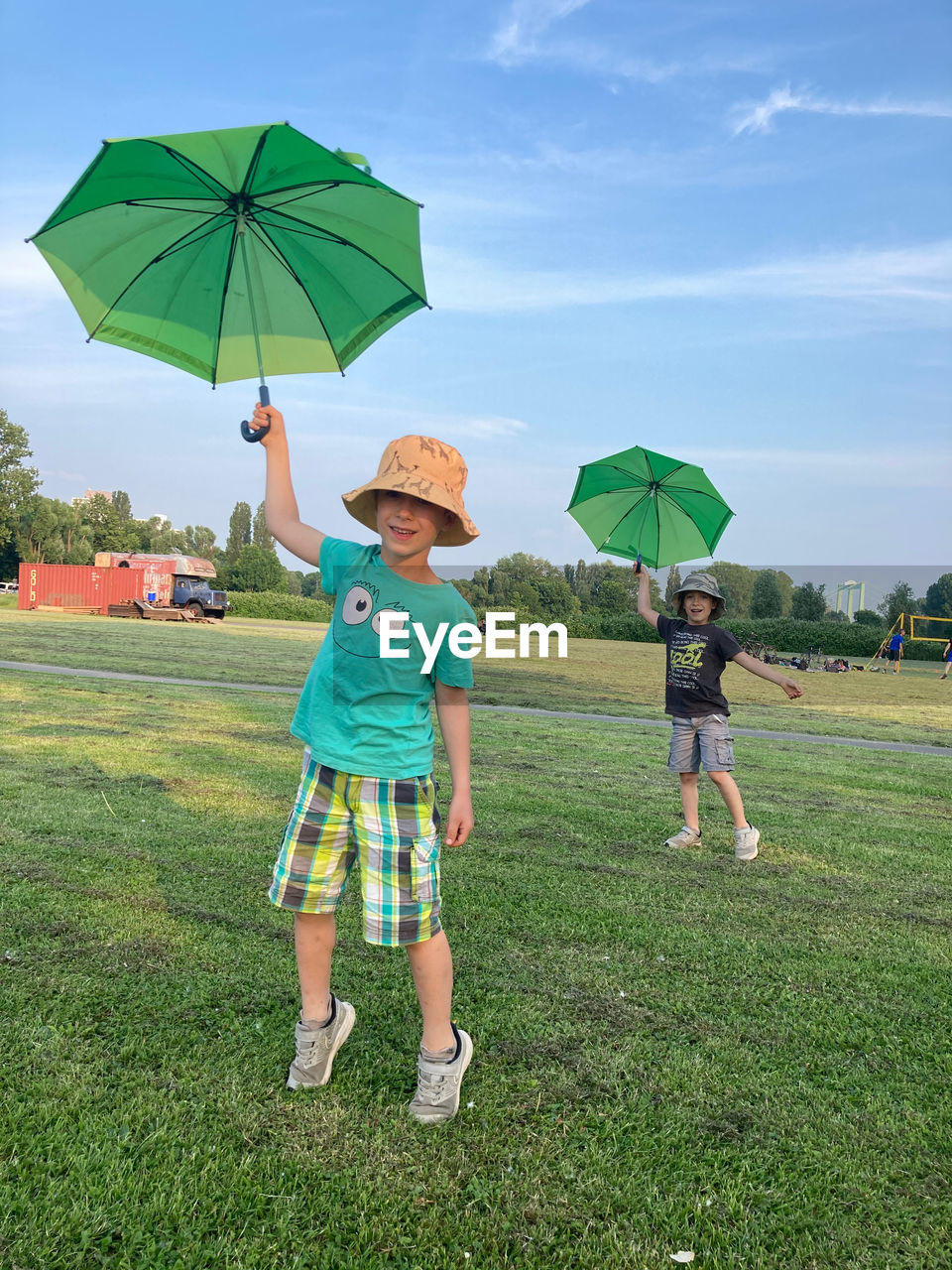 Rear view of woman with umbrella on field