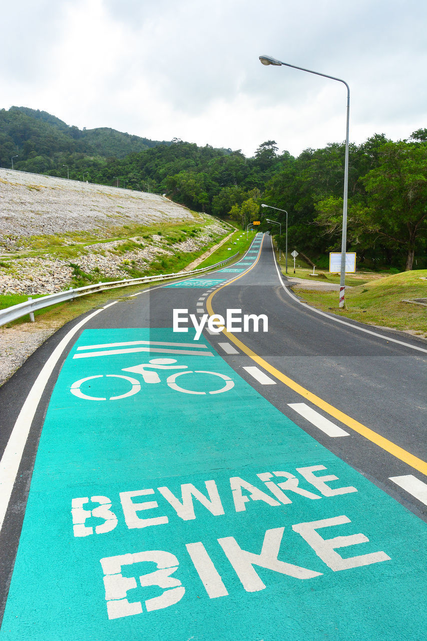 Beware bike sign painted on a bike lane in the dam area and public park