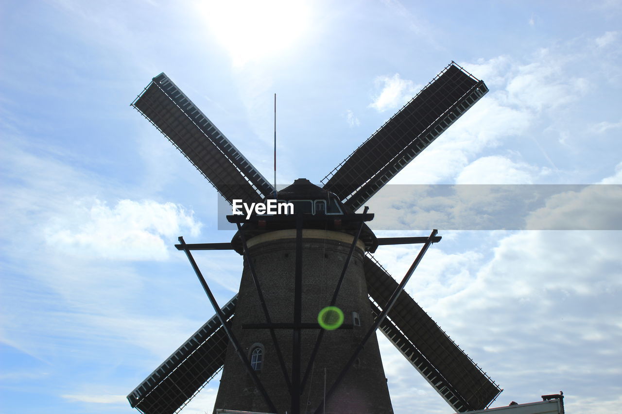 Low angle view of traditional windmill against sky