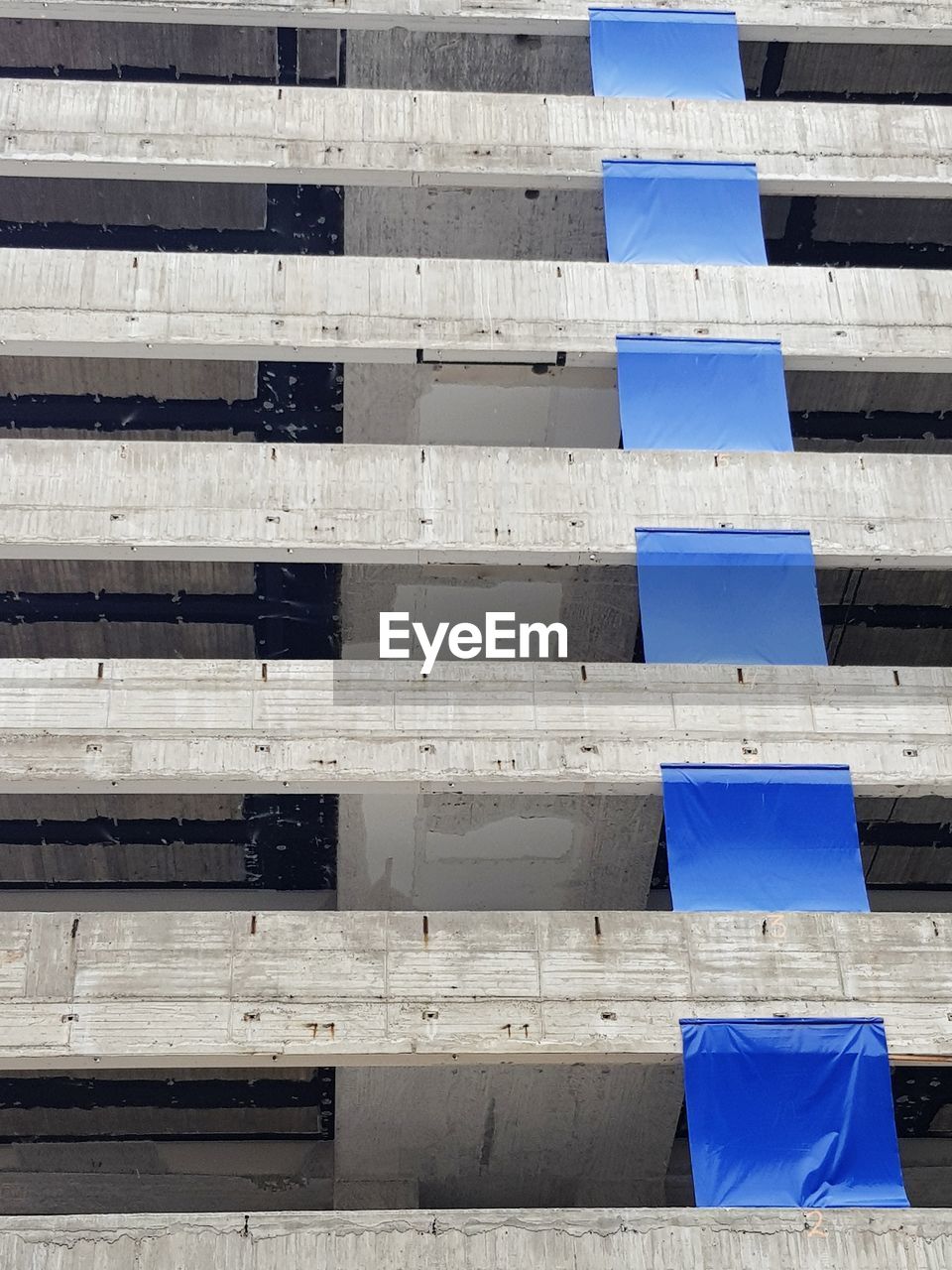 FULL FRAME SHOT OF BUILDING WITH STACK OF BLUE BACKGROUND