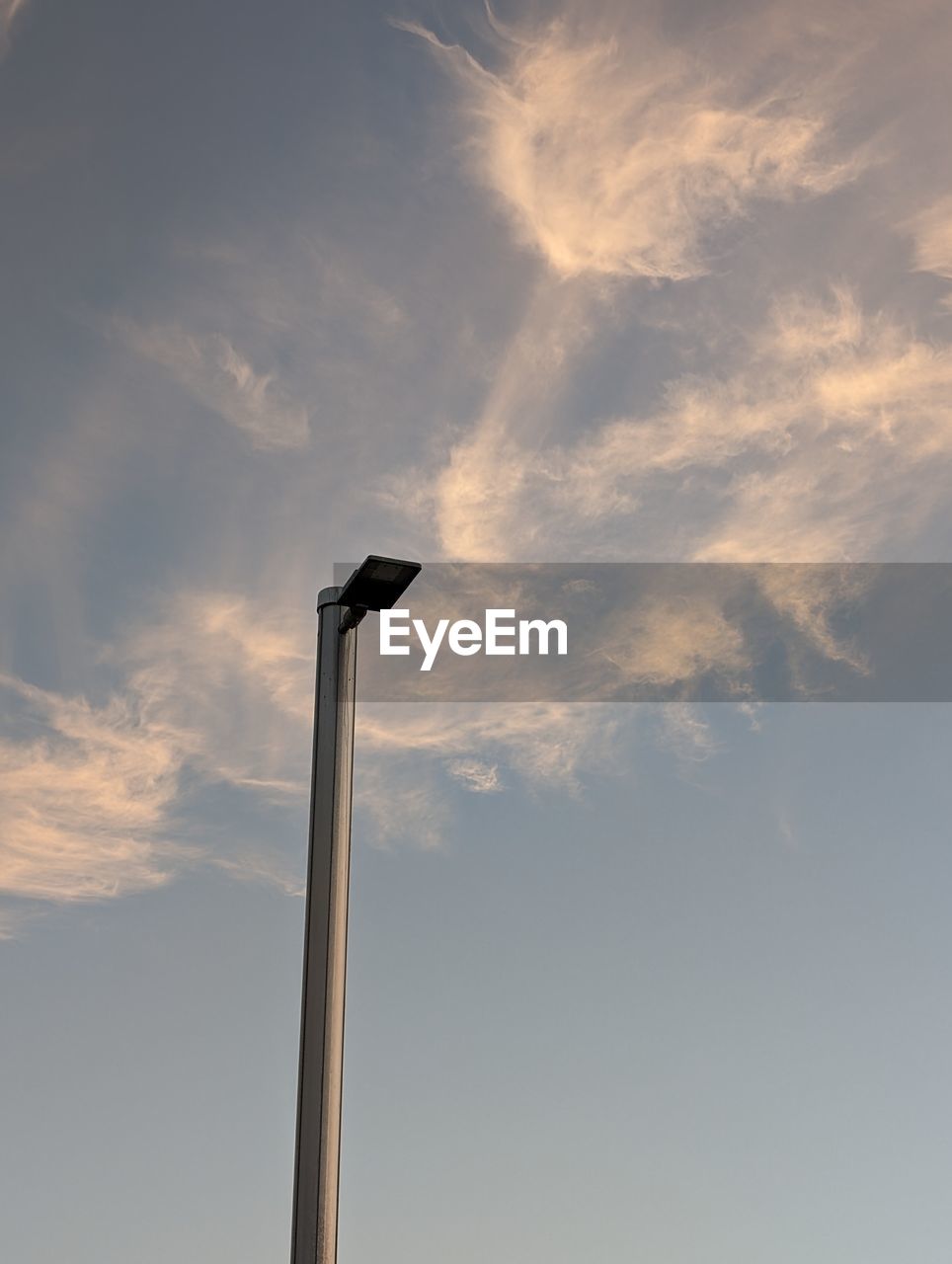 sky, cloud, low angle view, street light, nature, no people, wind turbine, lighting equipment, wind, pole, outdoors, street, day, lighting, copy space, technology, power generation, sunlight