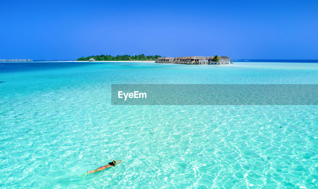 Scenic view of sea against clear blue sky