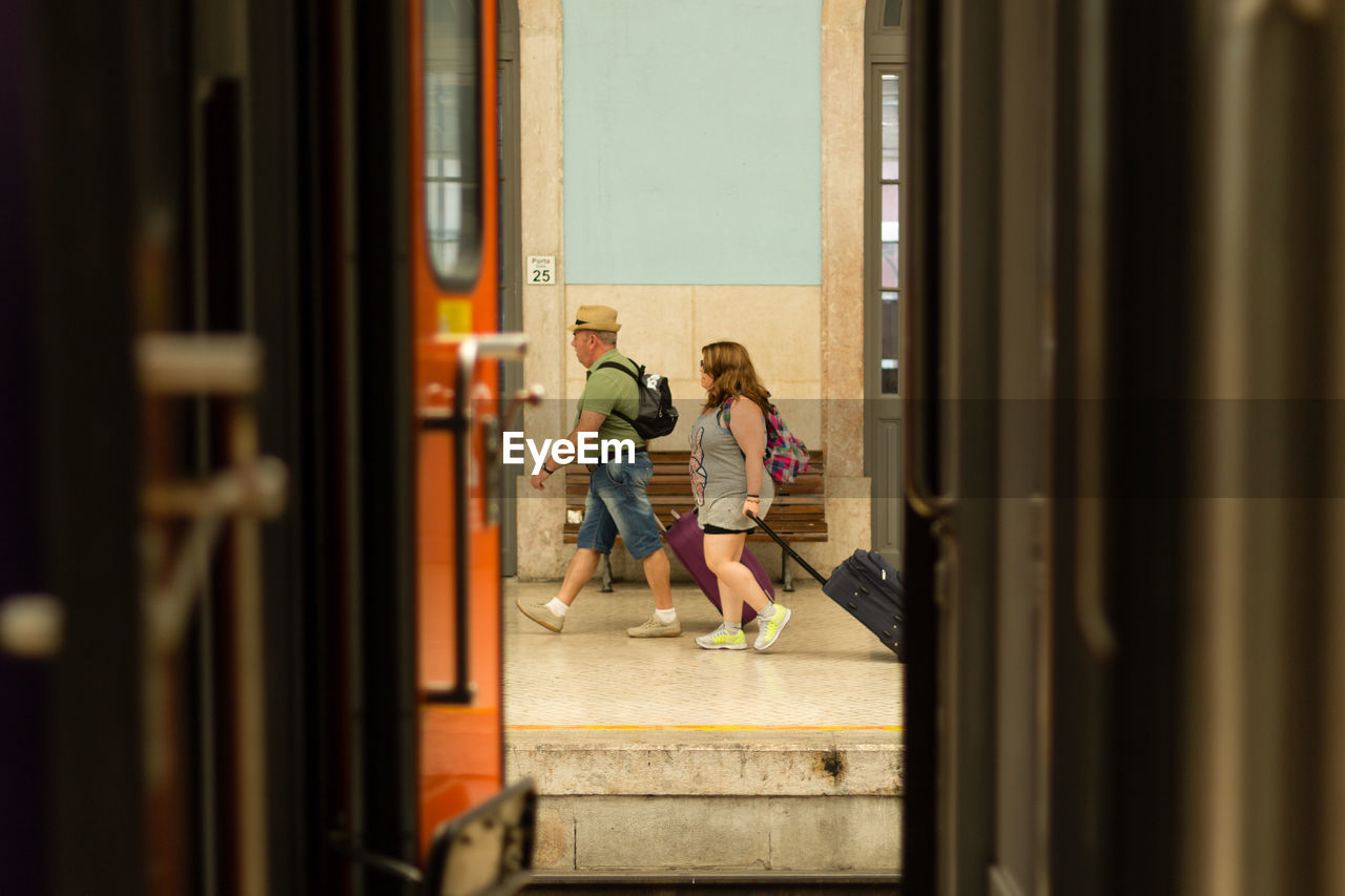 WOMAN LOOKING THROUGH WINDOW