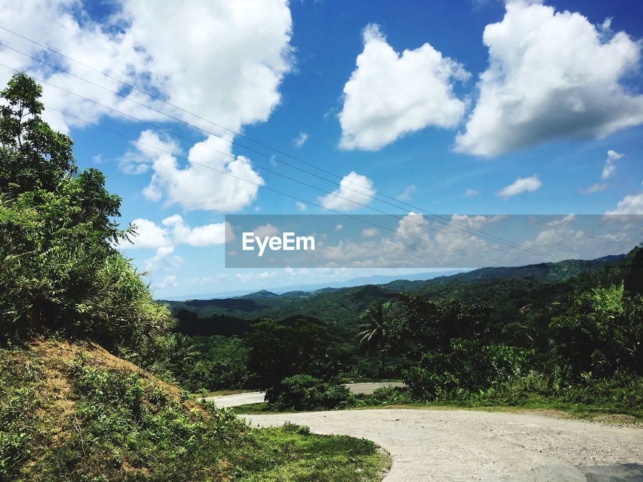 SCENIC VIEW OF MOUNTAINS AGAINST CLOUDY SKY