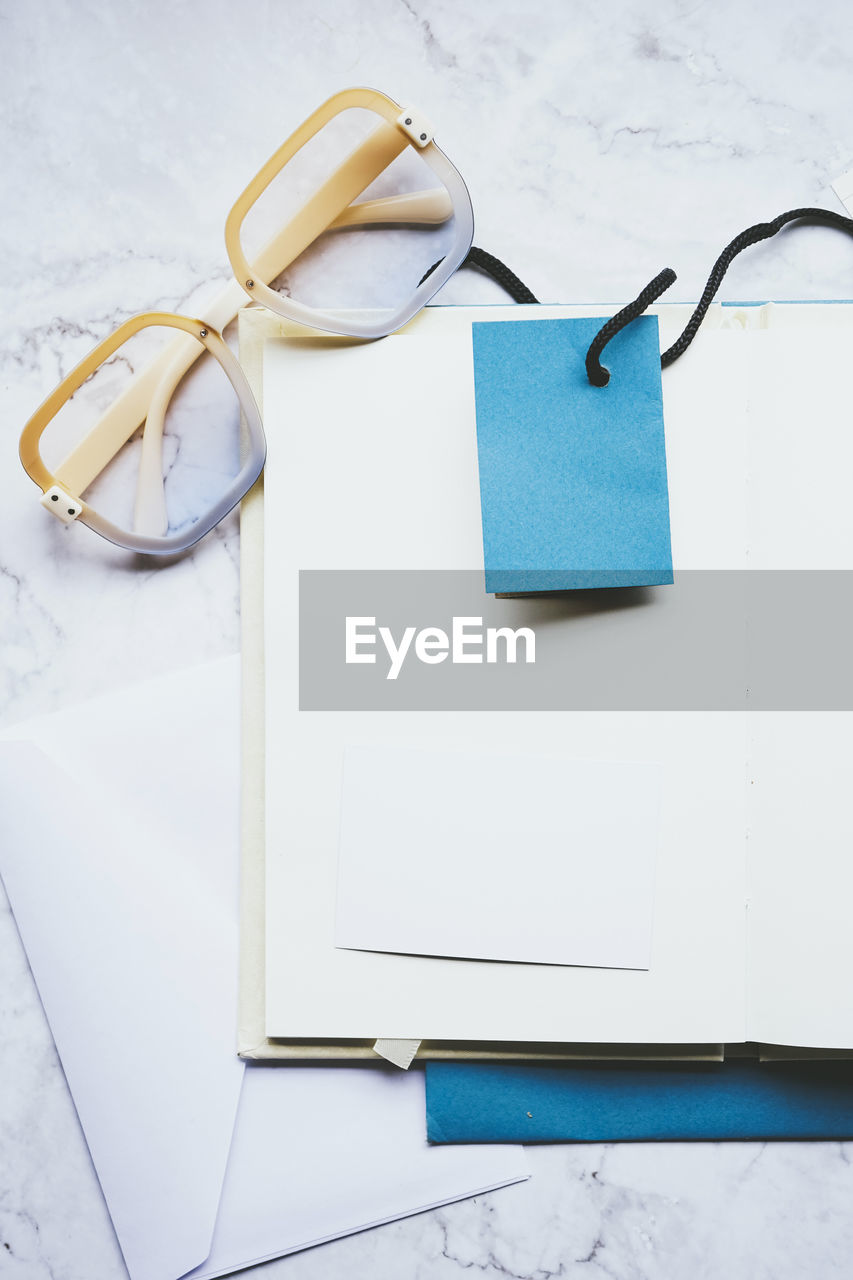 indoors, no people, glasses, studio shot, eyeglasses, still life, copy space, blue, high angle view, paper
