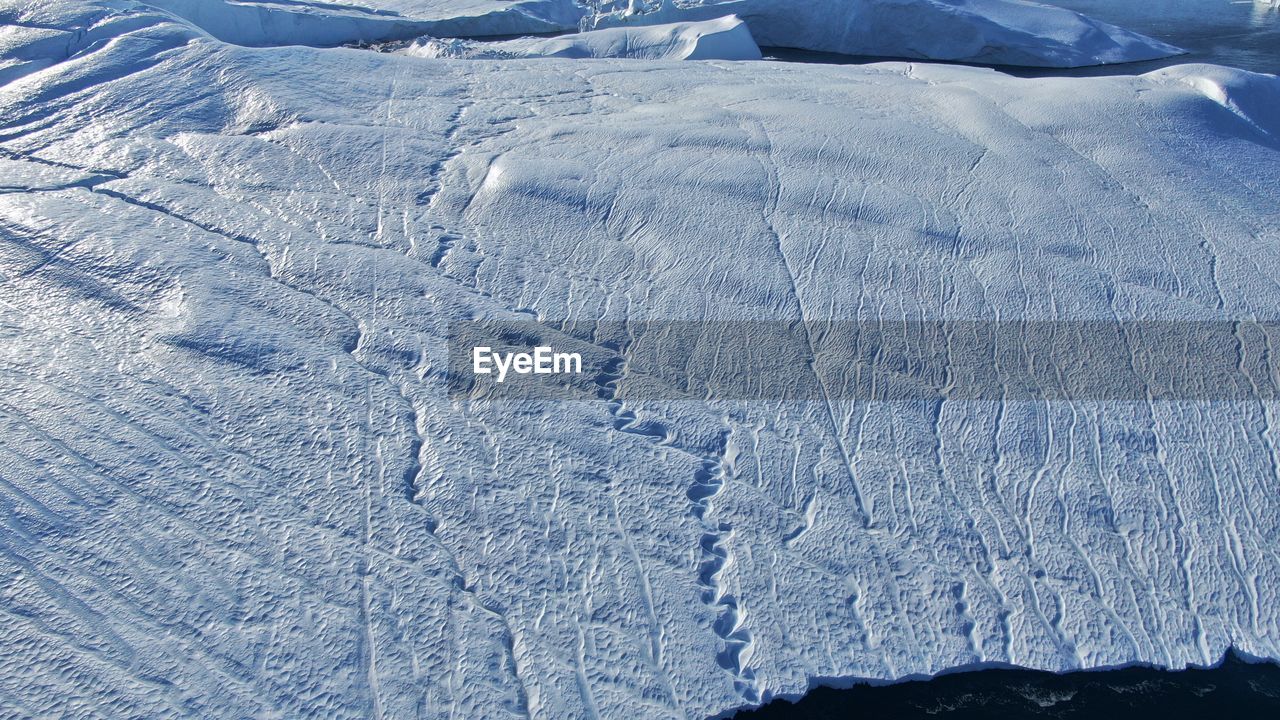 HIGH ANGLE VIEW OF SNOW FIELD