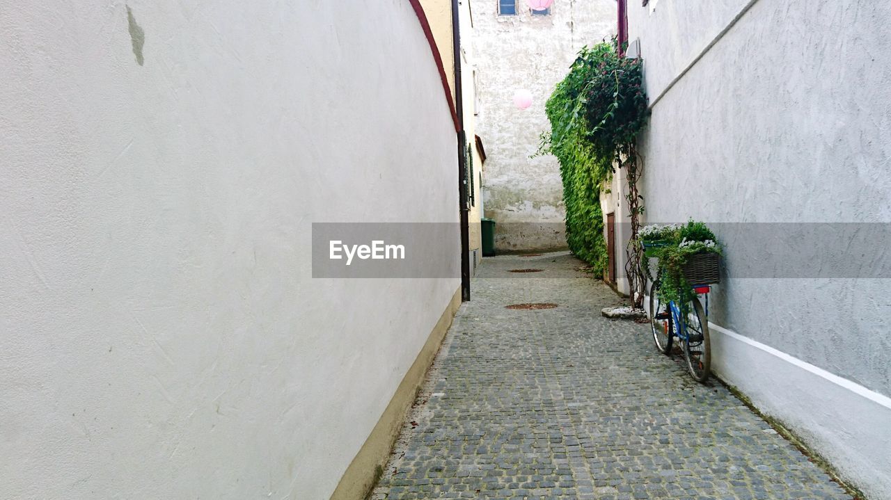 Bicycle on street by wall