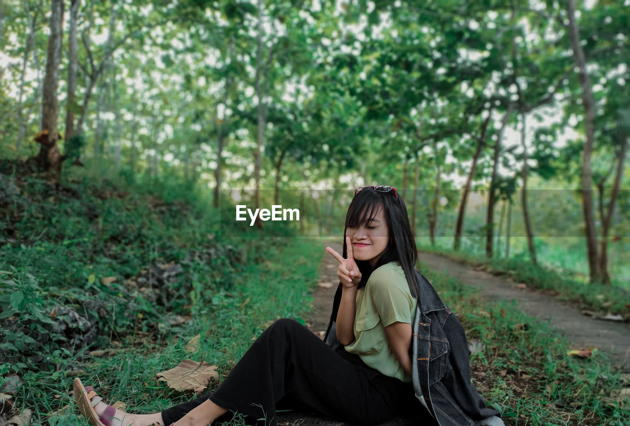 Young woman sitting in the forest