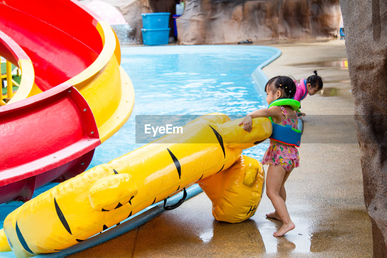 Girl playing with pool raft