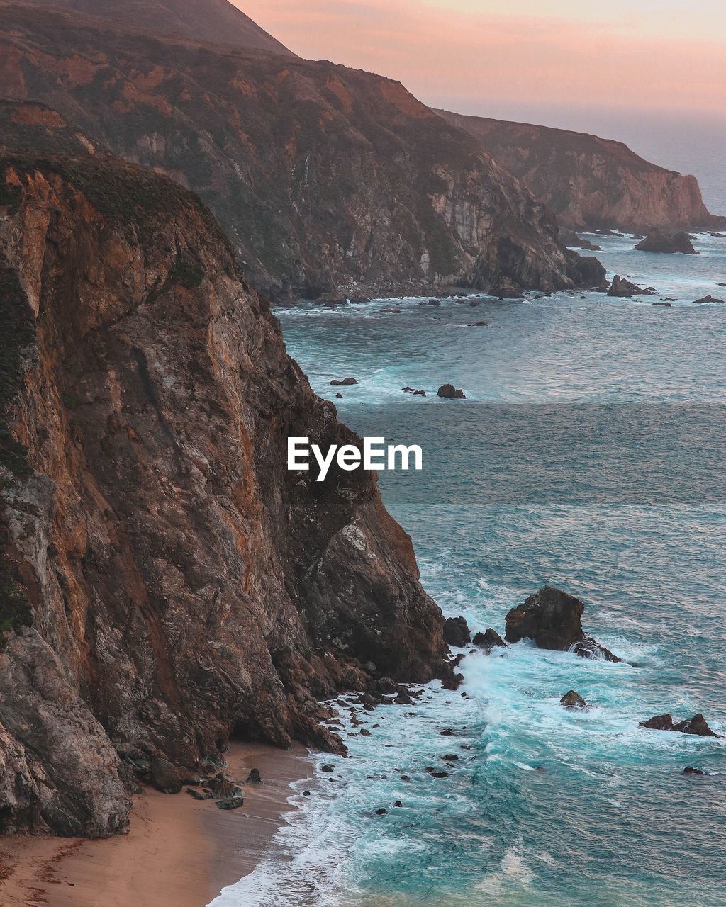 Scenic view of sea and mountains against sky