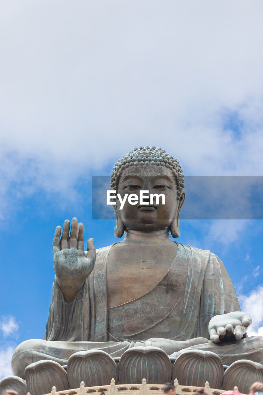 LOW ANGLE VIEW OF STATUE OF BUDDHA AGAINST SKY