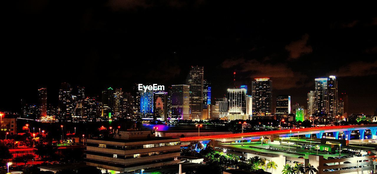 Panoramic view of illuminated cityscape at night