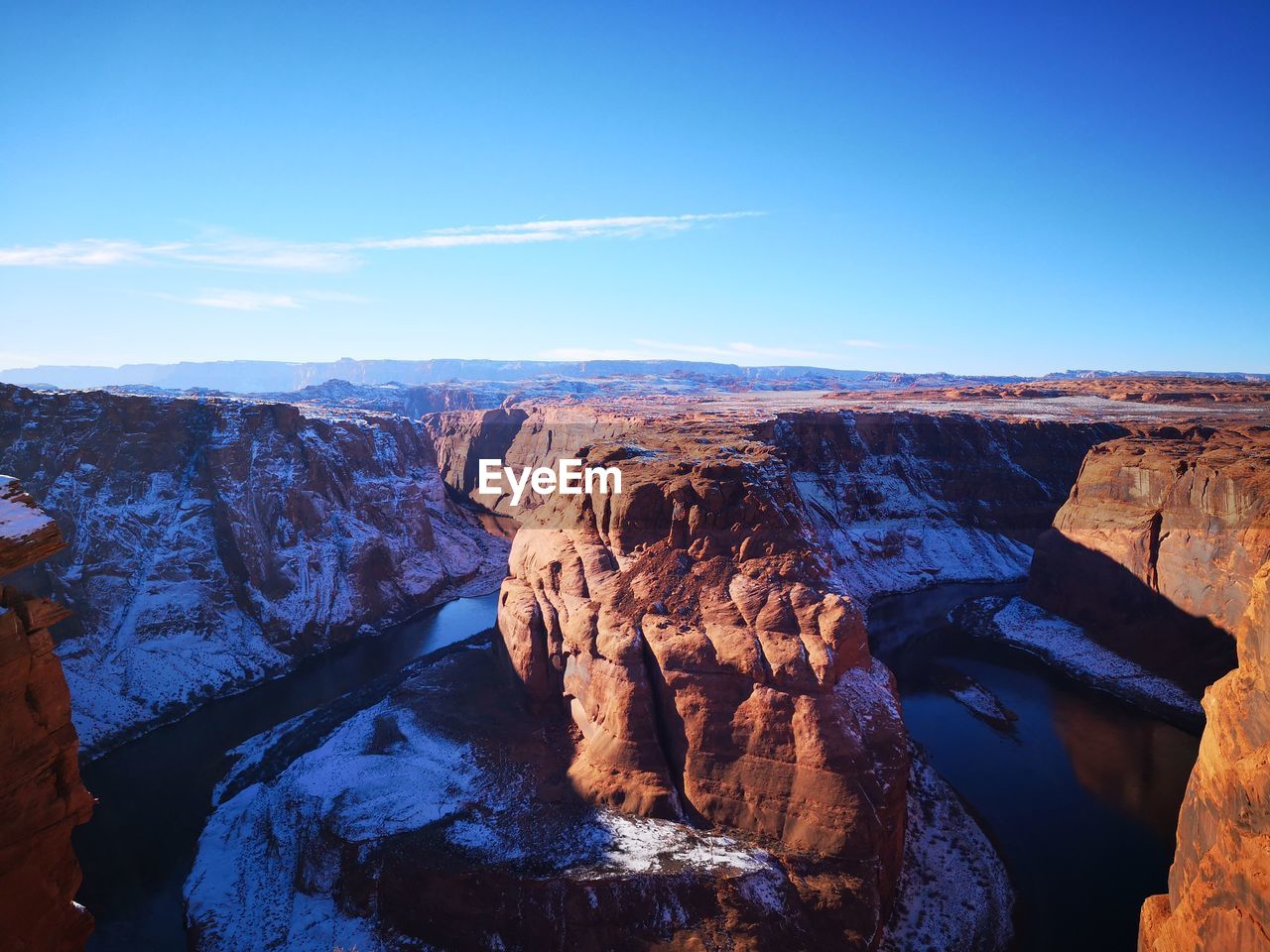 Panoramic view of rock formations against blue sky