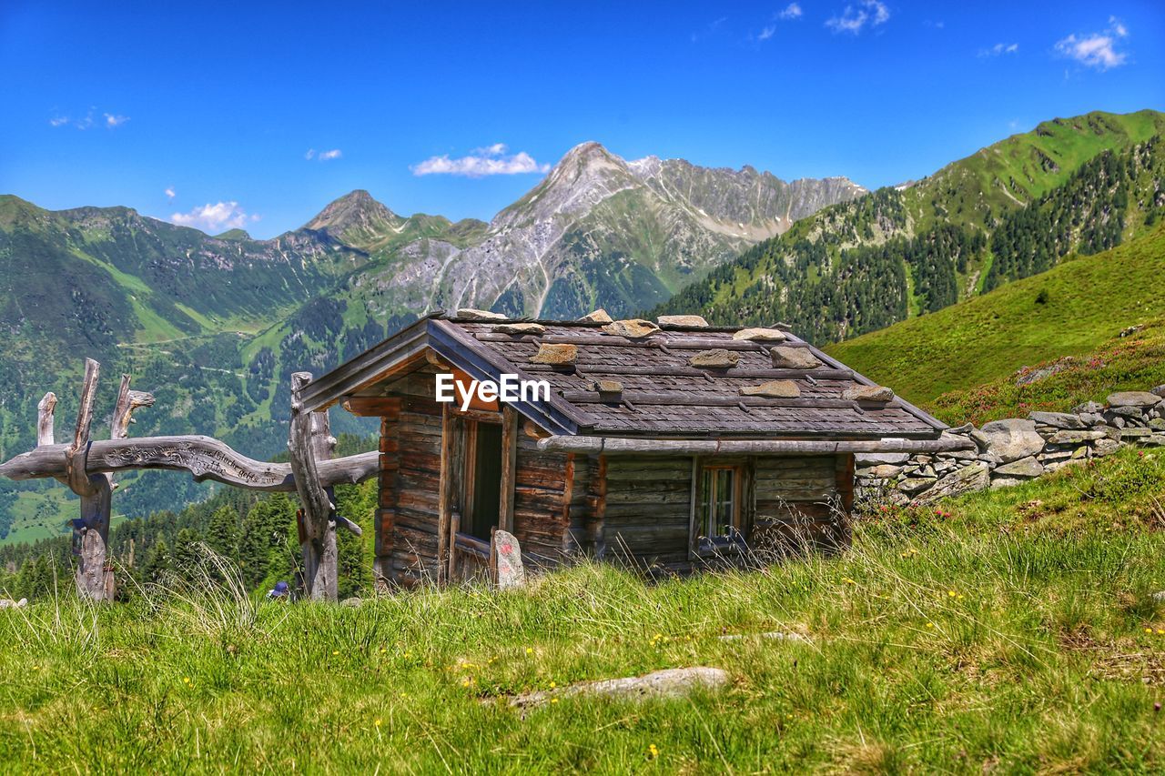 House on mountain against sky