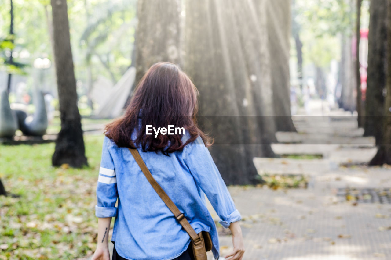 Rear view of woman walking at park