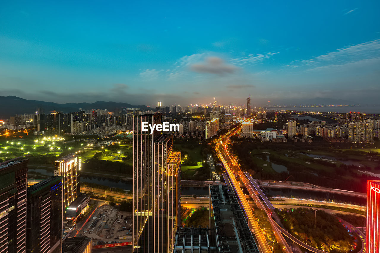 High angle view of illuminated city buildings at night