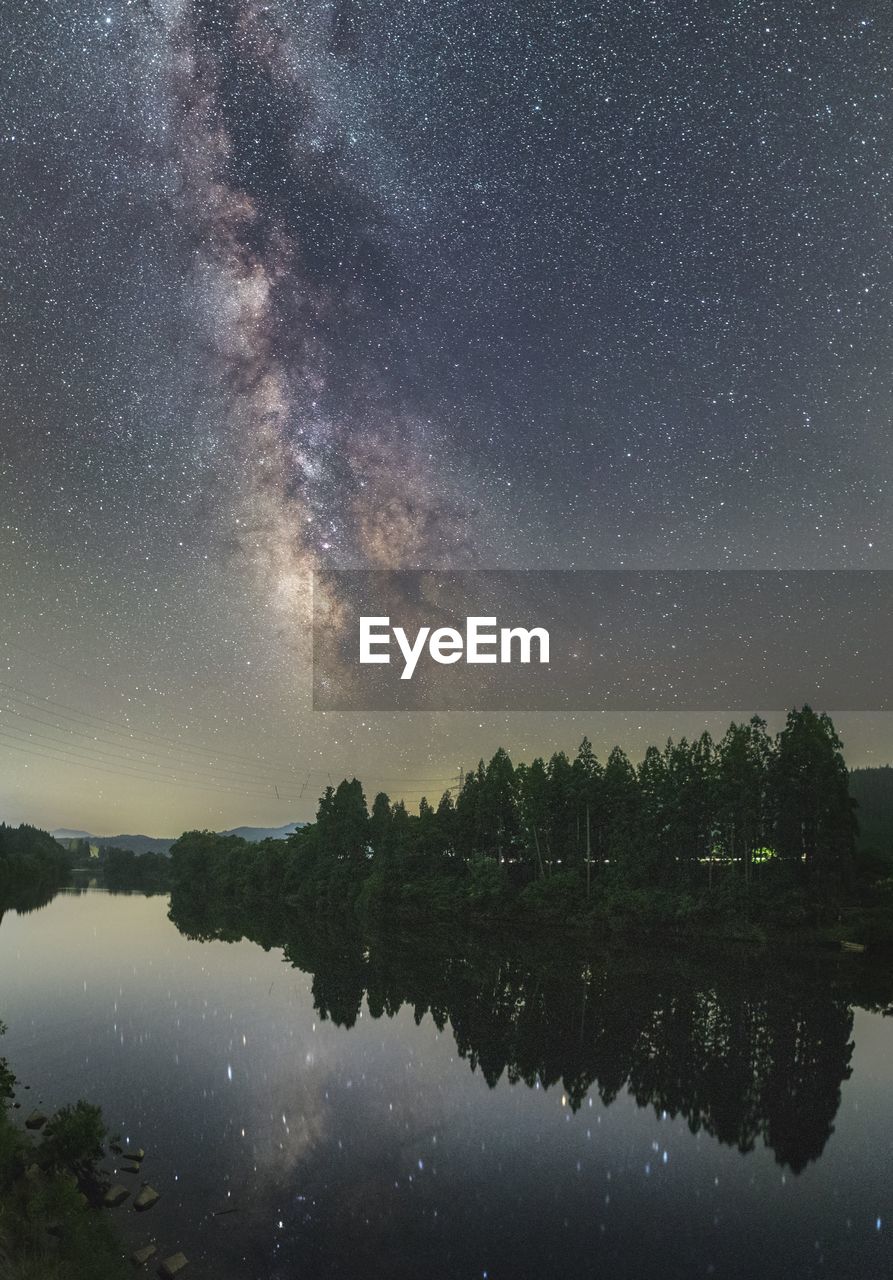 Scenic view of lake against sky at night