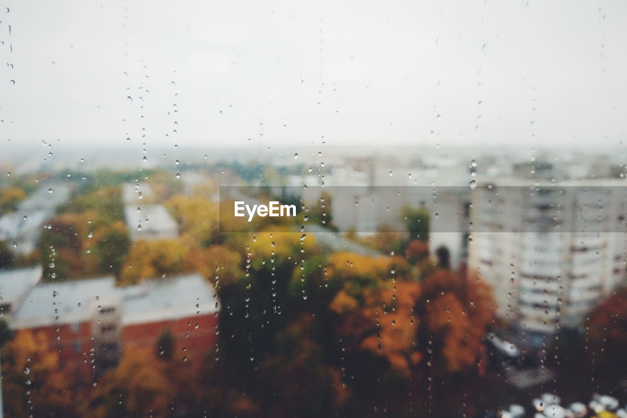 Buildings seen through wet window during rainy season