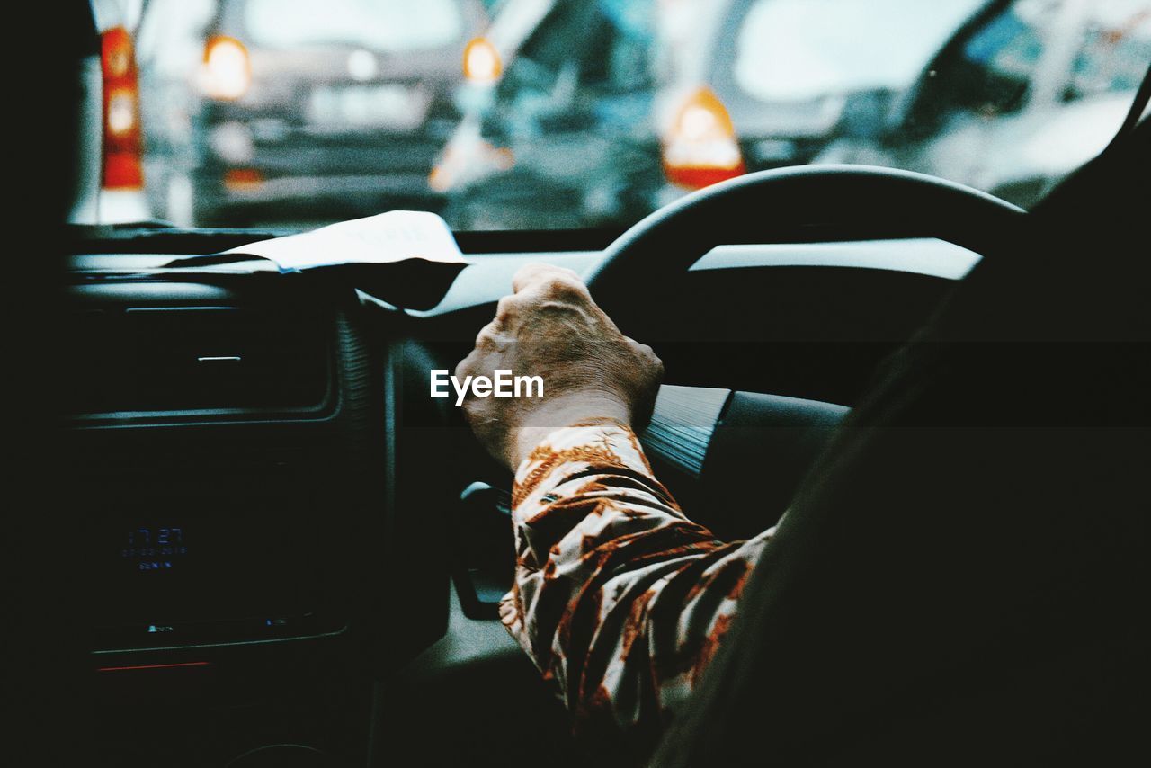 Cropped image of man driving car