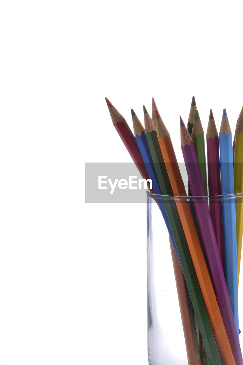 Close-up of colored pencils against white background