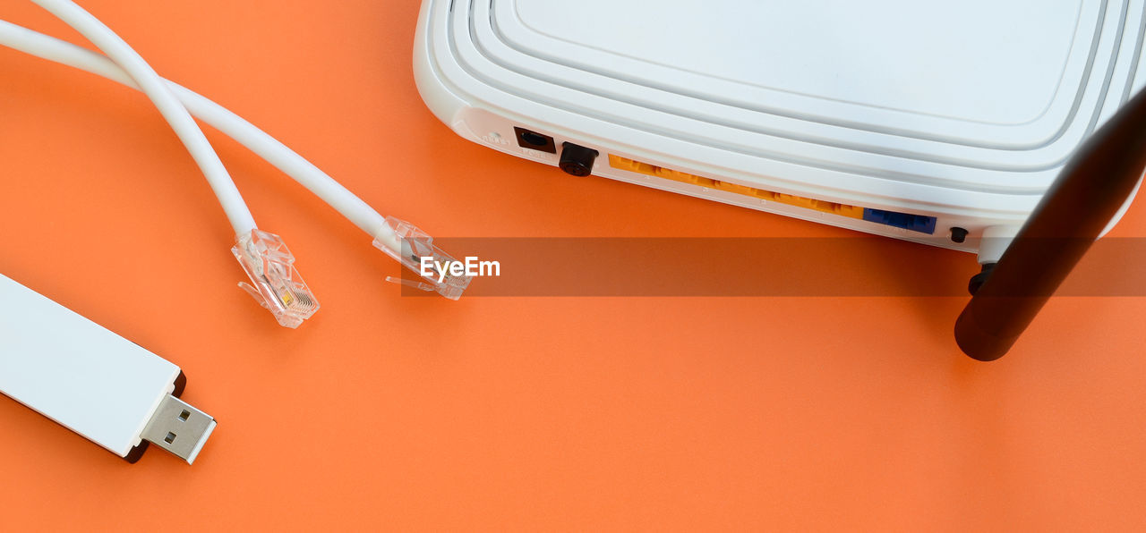 Close-up of router with cables on orange background