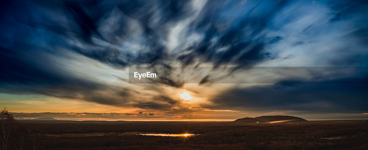 Scenic view of dramatic sky over land