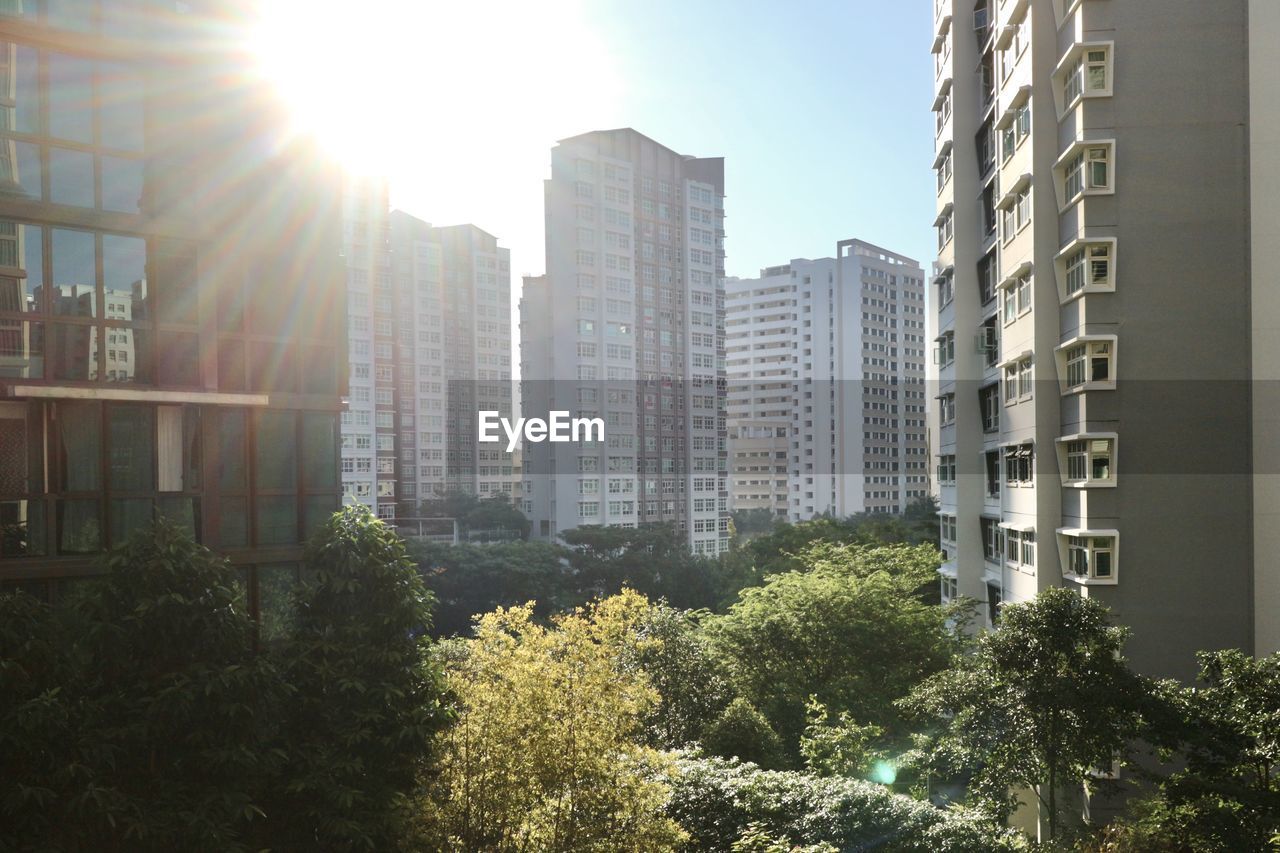 Modern buildings against sky on sunny day