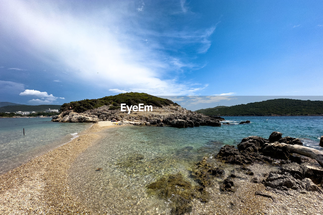 water, sea, land, sky, beach, scenics - nature, body of water, ocean, shore, beauty in nature, coast, nature, cloud, rock, travel destinations, coastline, tranquility, environment, travel, blue, sand, landscape, tranquil scene, horizon, wave, island, holiday, trip, vacation, cove, bay, no people, idyllic, tourism, outdoors, mountain, seascape, bay of water, summer, lagoon, day, non-urban scene, tropical climate, sunlight, water's edge