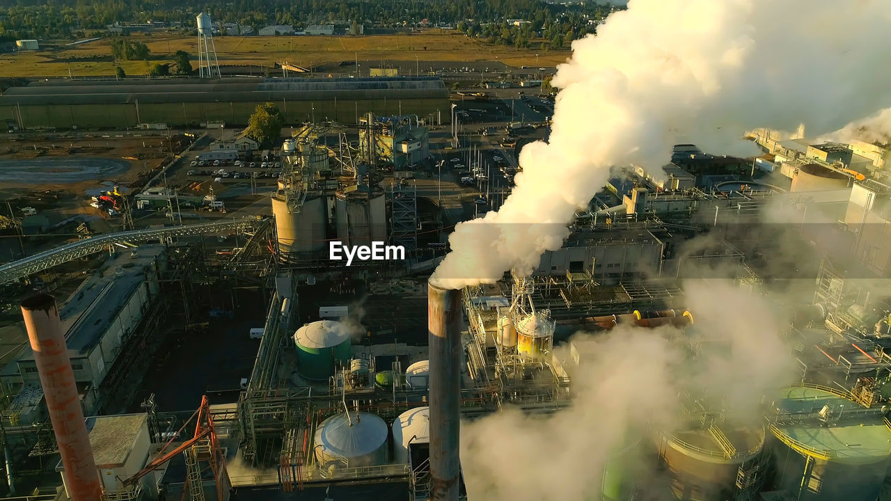 smoke, industry, pollution, environment, environmental issues, factory, power generation, architecture, air pollution, nature, building exterior, business finance and industry, built structure, aerial photography, aerial view, vehicle, outdoors, screenshot, transport, fossil fuel, high angle view, no people, smoke stack, business