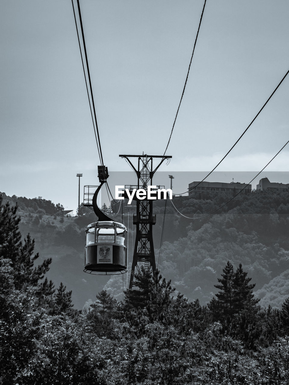 Low angle view of overhead cable car against sky