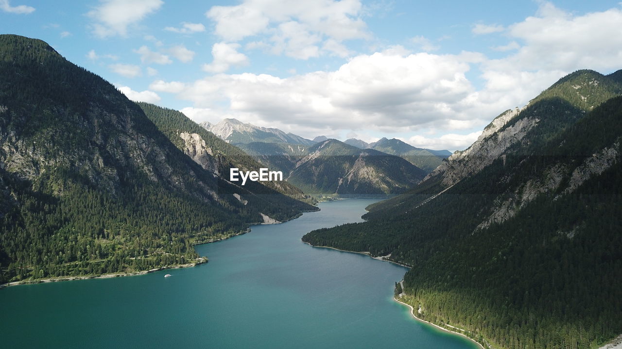 Scenic view of lake amidst mountains against sky