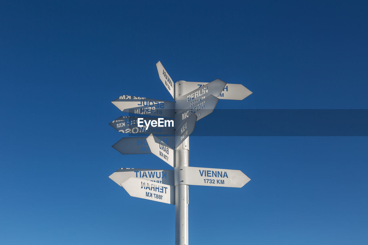 LOW ANGLE VIEW OF SIGN AGAINST BLUE SKY