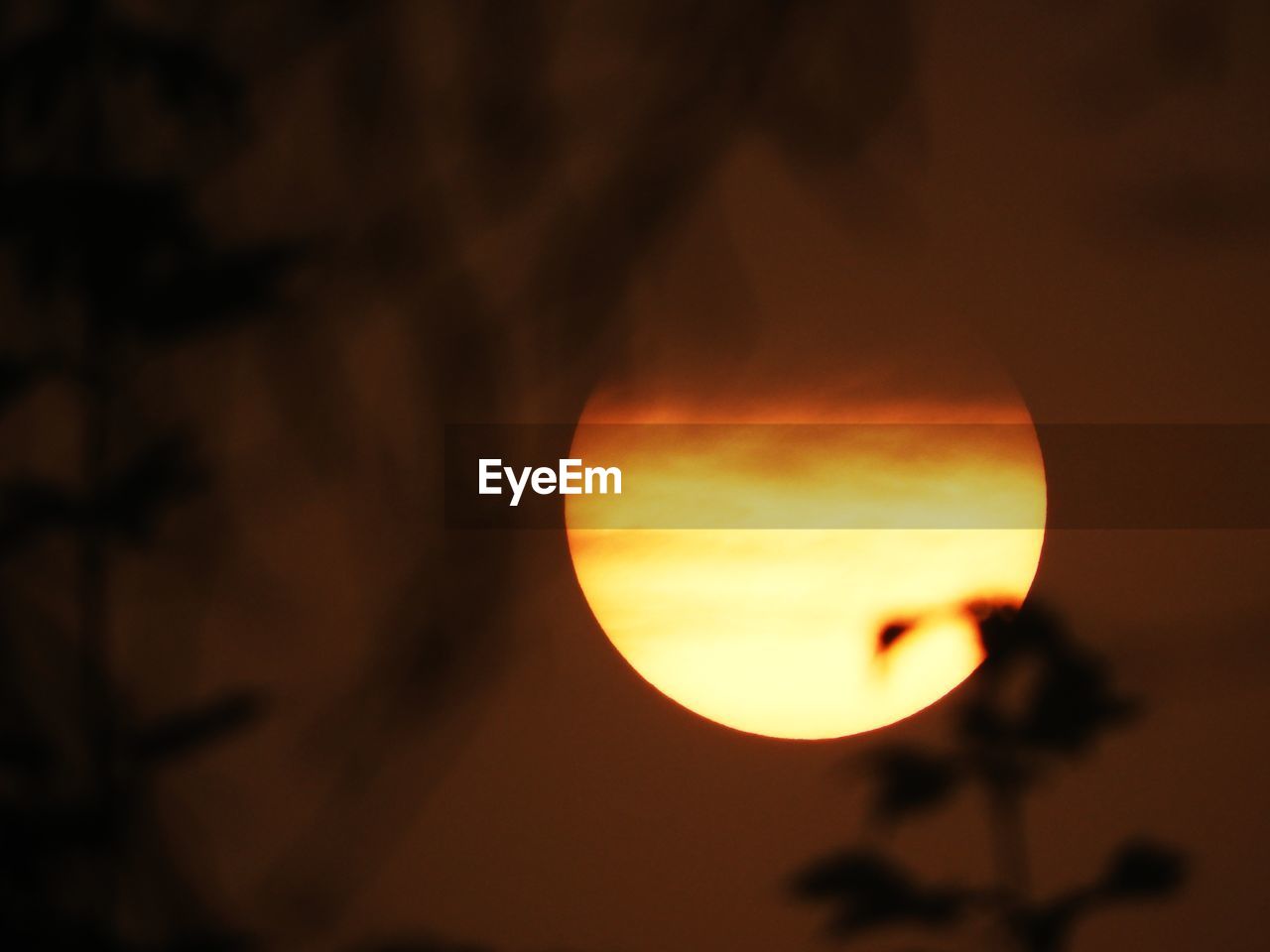 CLOSE-UP OF MOON AGAINST SKY AT SUNSET