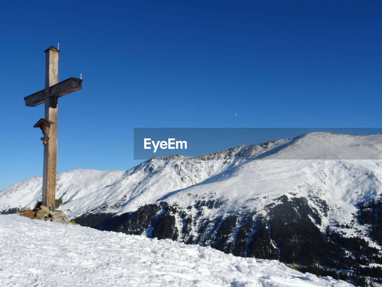 Scenic view of snowcapped mountains against clear blue sky