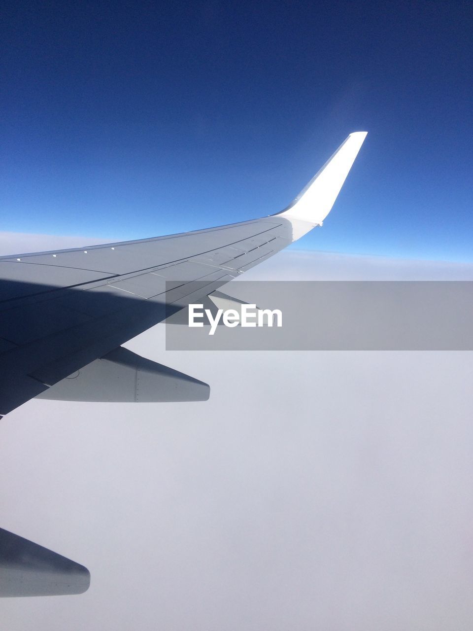 AIRPLANE WING AGAINST CLEAR SKY