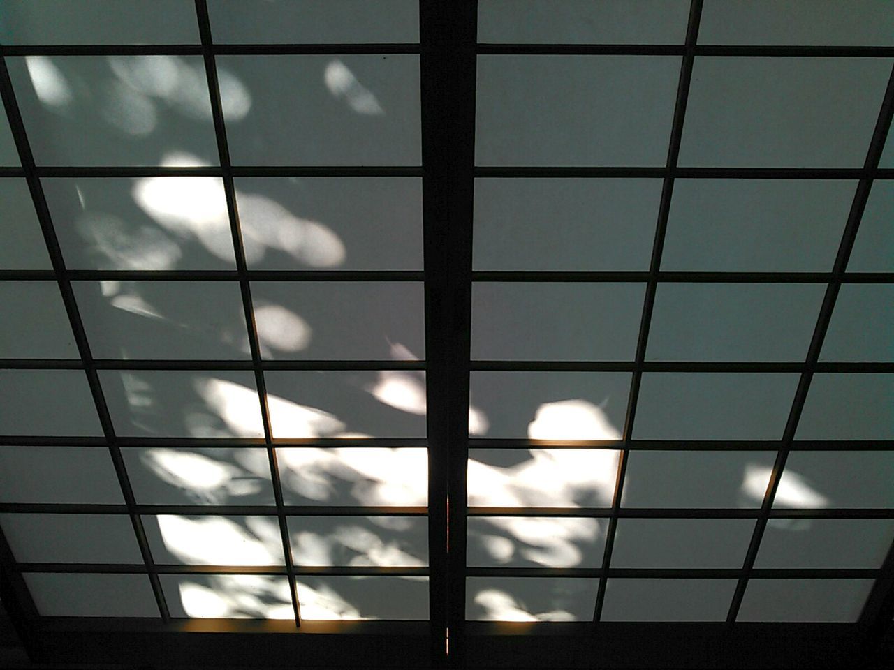 Low angle view of sky seen through glass window