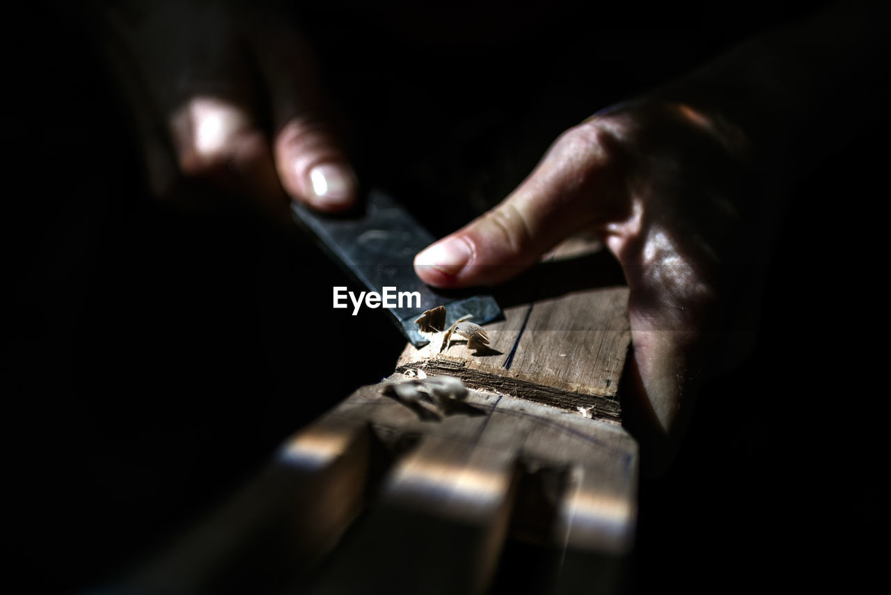 Unrecognized luthier woman in traditional workshop