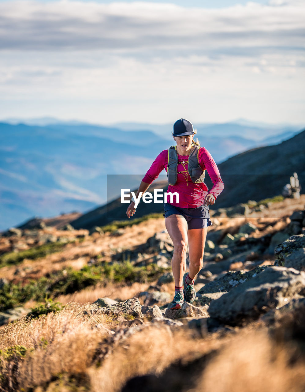 Woman running in the white mountains in early morning