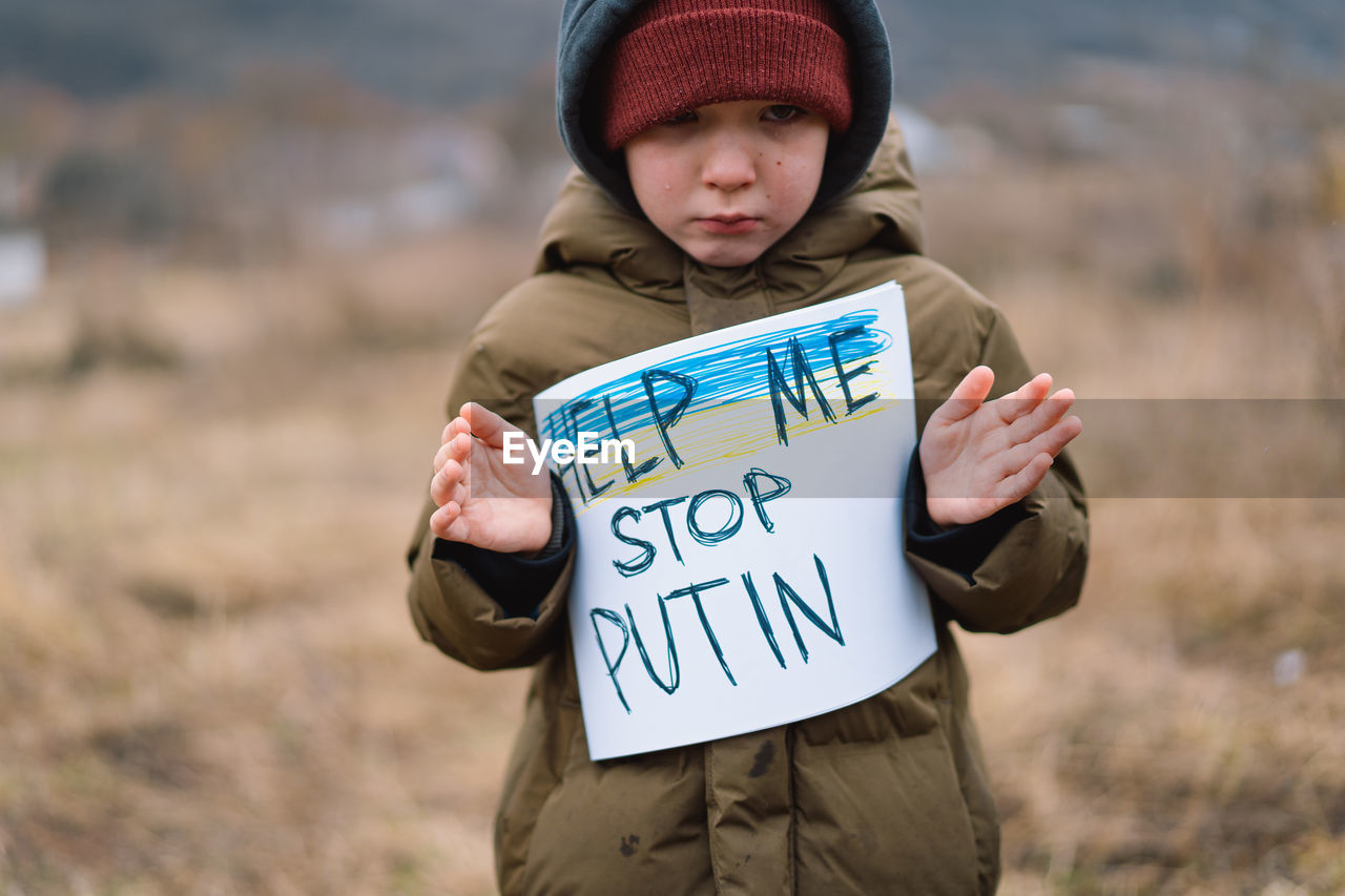 War of russia against ukraine. crying boy asks to stop the war in ukraine.