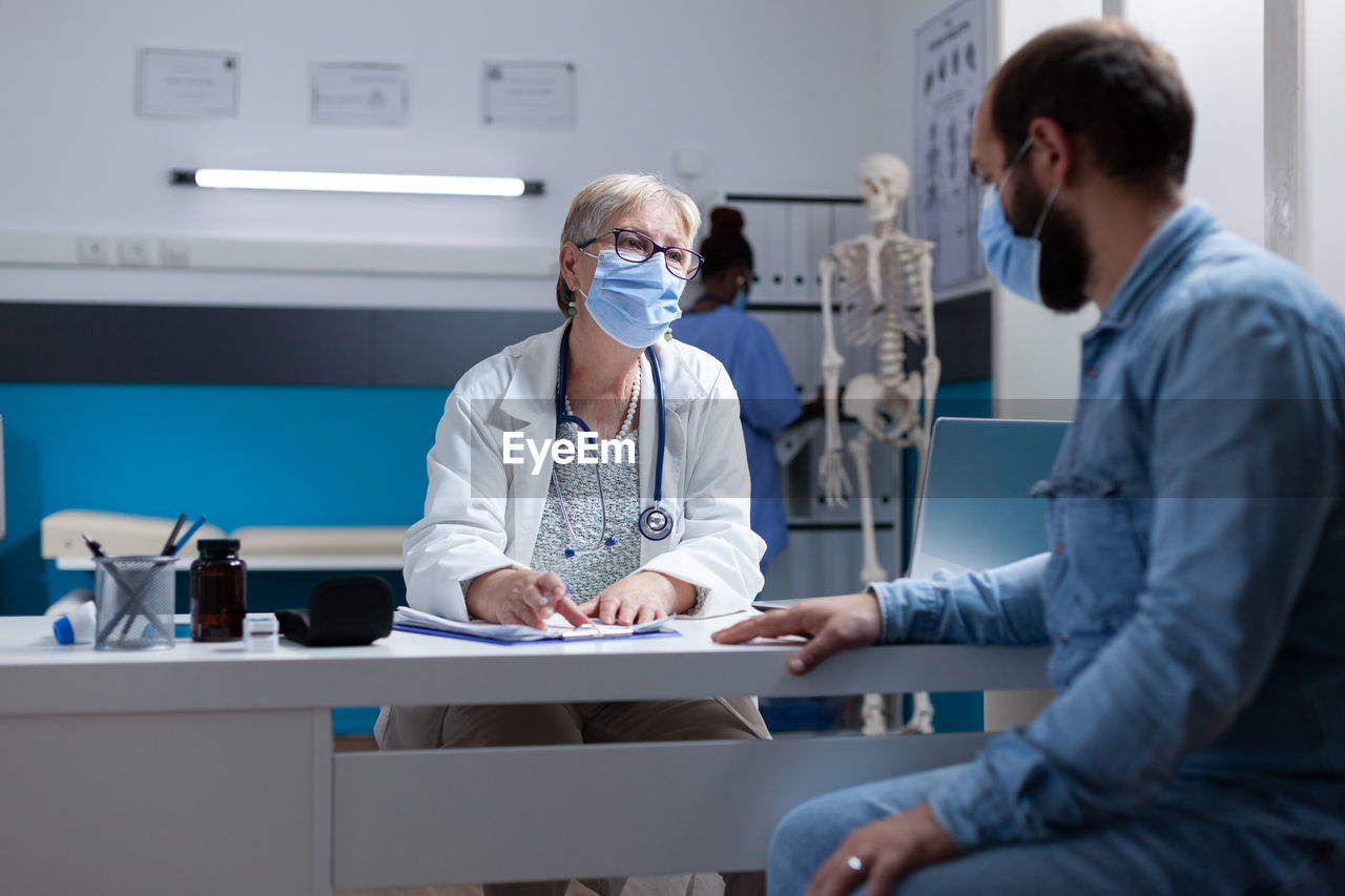 female doctor examining patient in office