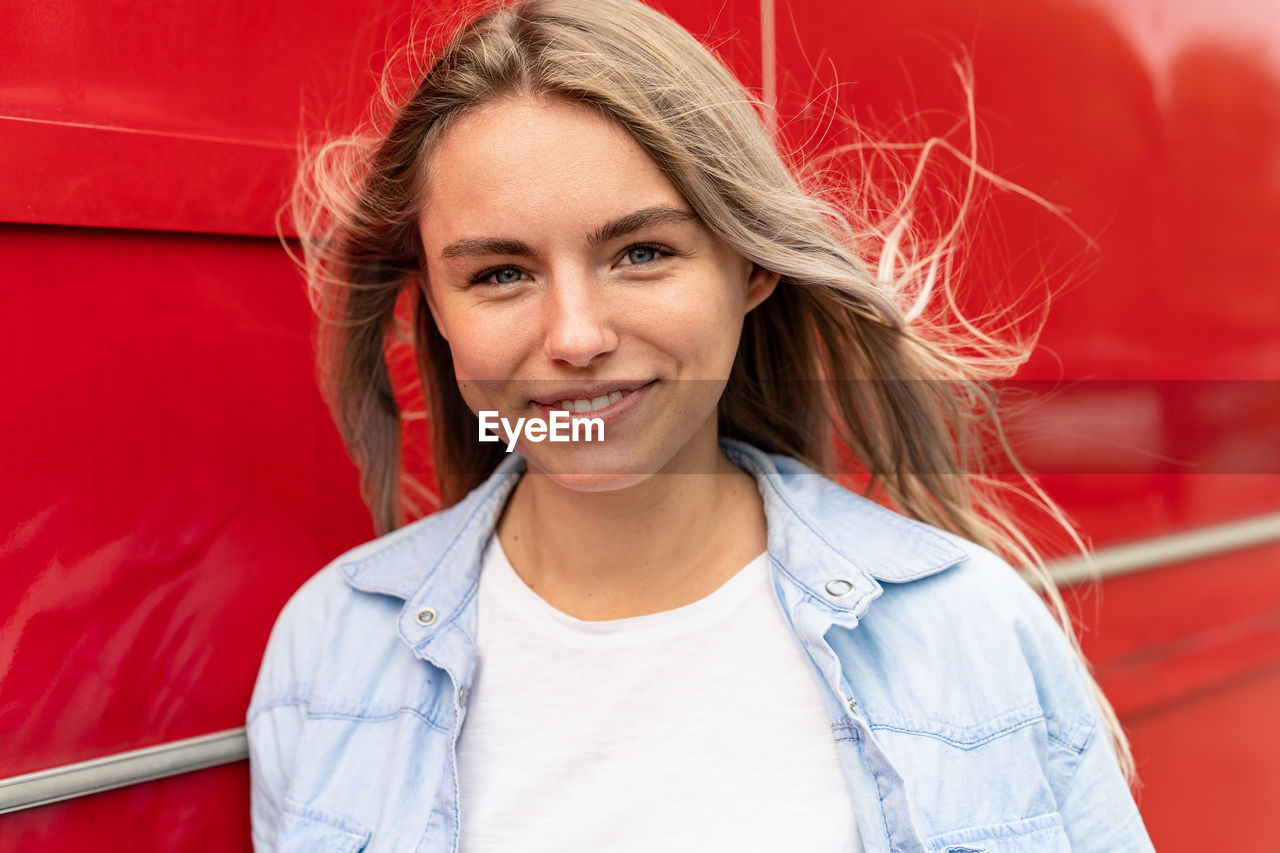 Portrait of smiling young woman standing outdoors