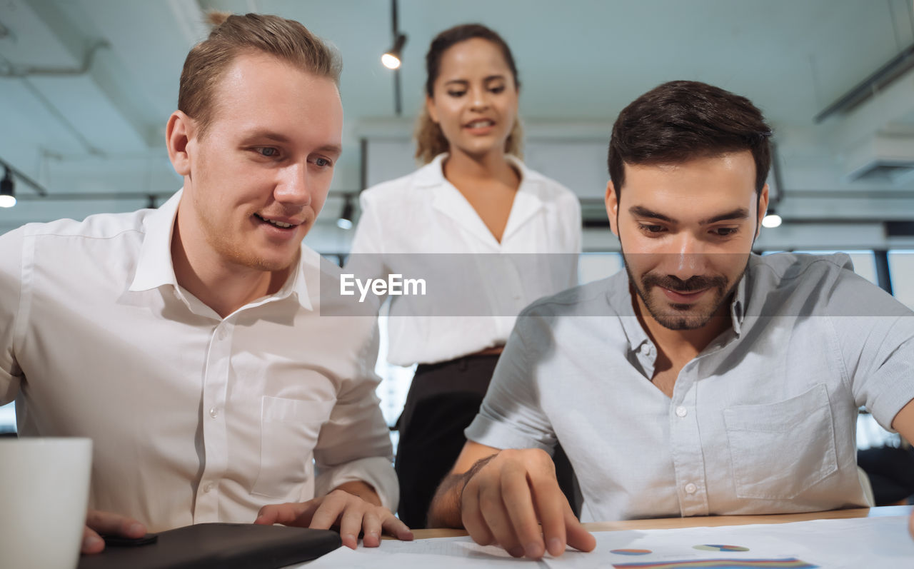 Business people discussing paperwork in office