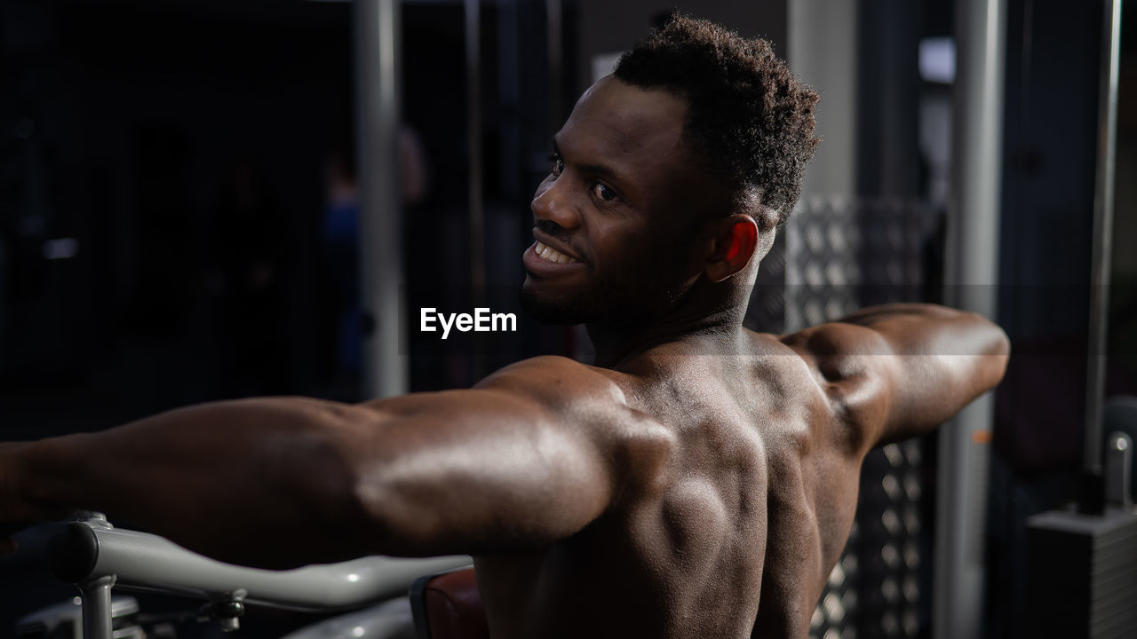 side view of man exercising in gym