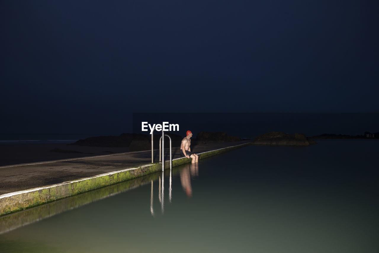 Sportsman sitting at pool during dawn