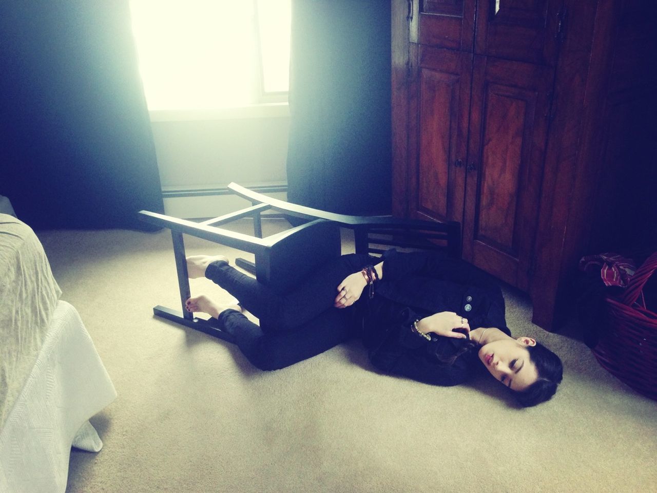 Young woman lying on floor in the room