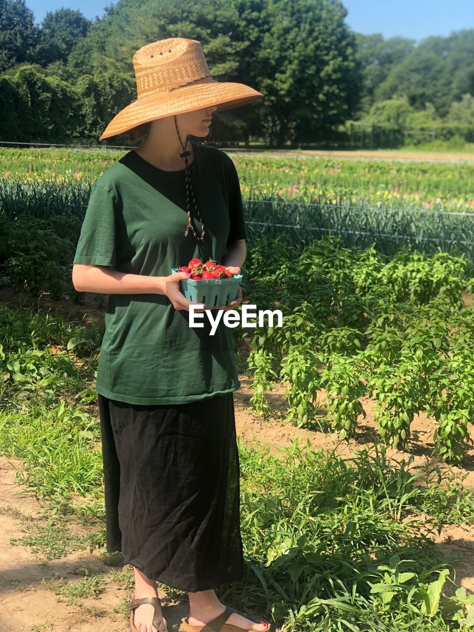 MAN WEARING HAT STANDING IN FARM