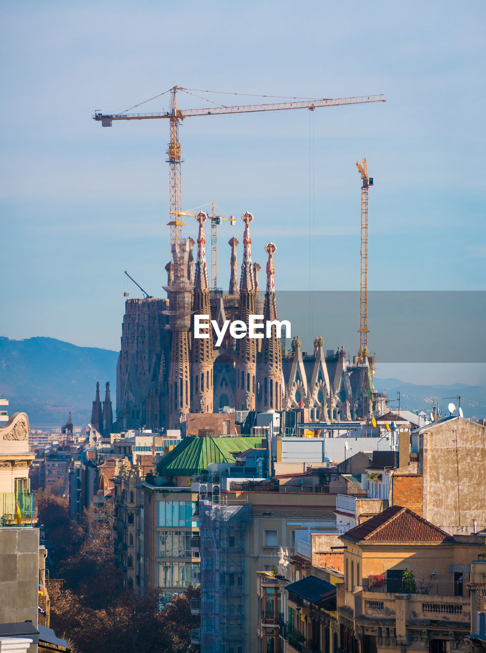 Construction site by buildings against sky