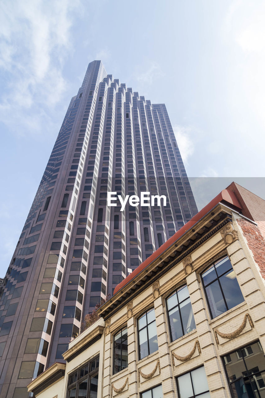 LOW ANGLE VIEW OF MODERN BUILDINGS AGAINST SKY IN CITY